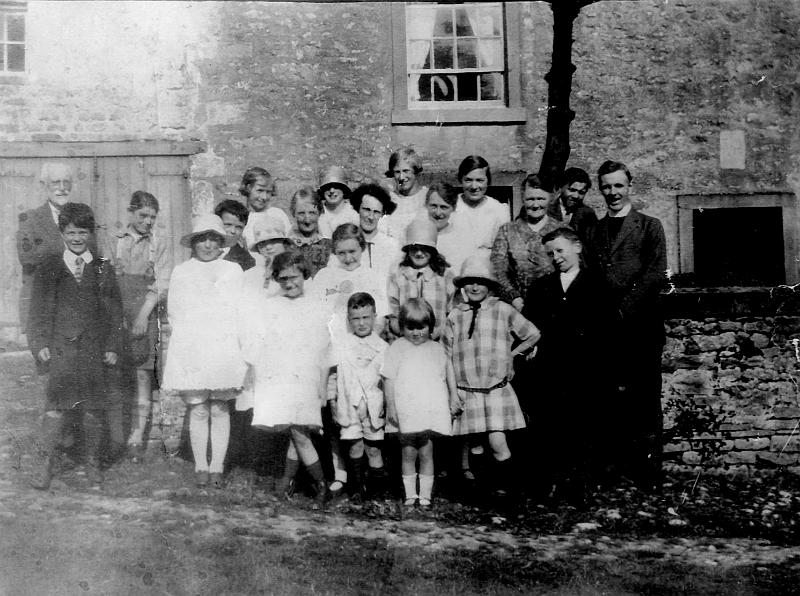 Methodists 1930.JPG - Long Preston Methodist Chapel - Sunday School - outing c 1930  Back Row:  Mary Kettlewell ( Town Head Farm)  - unknown girl - Alice Kettlewell - Annie Hindson - unknown boy  Second Row:   Mr Elson at far left - rest unknown - on the far right is the Minister  Third Row:   unknown boy - three unknown girls - Alice Cooke (in hat) - unknown boy  Front Row:   Rosie Bullock  - small unknown boy & girl - Annie Cooke ( Mear beck)